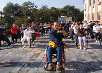 Dr.Guo instructs participants at the First National Wheelchair Tai Ji Quan instructors' Workshop in Beijing 2006